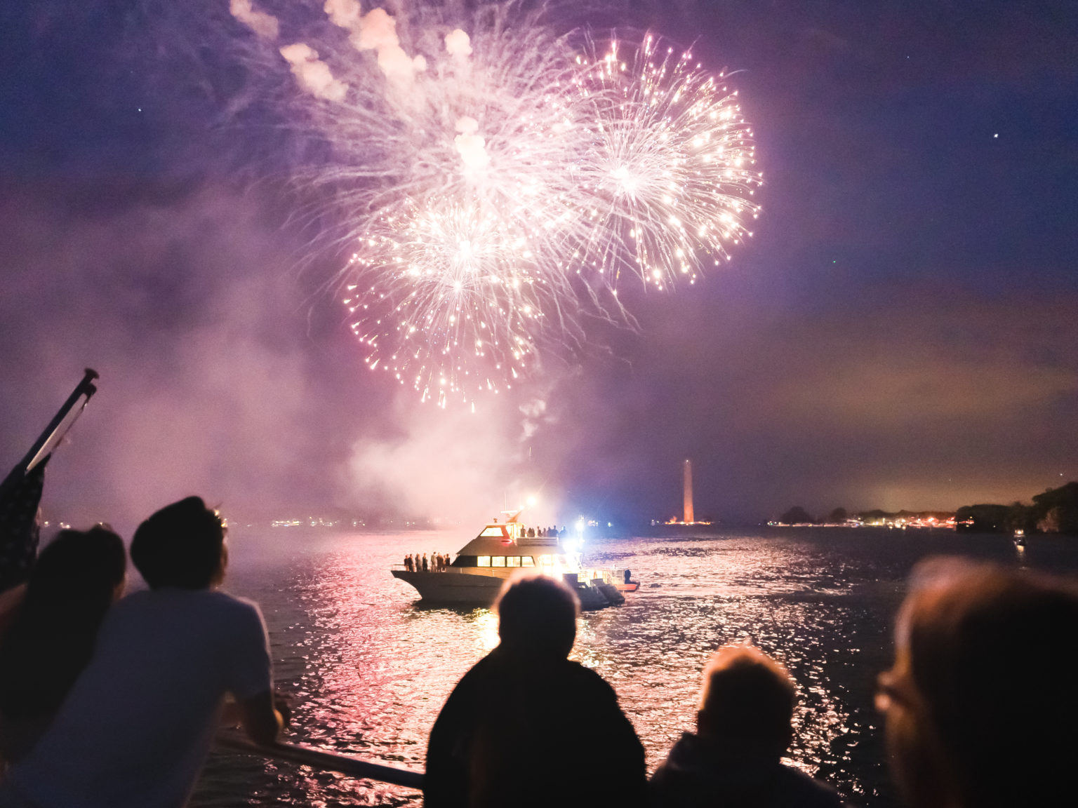 a group of people watching fireworks in the sky