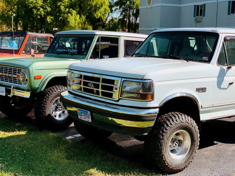 a car parked in front of a truck