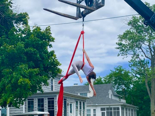 a person in a swing in front of a building