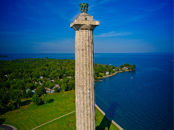 a clock tower next to a body of water