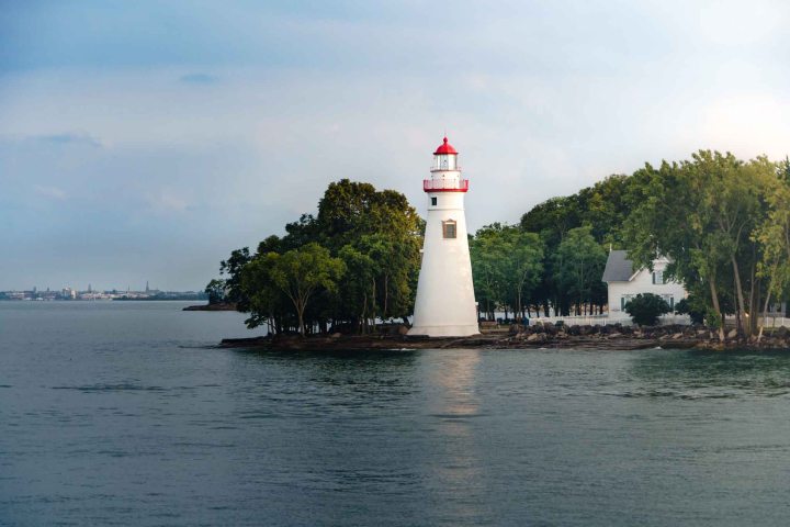 a small clock tower in the middle of a body of water