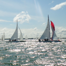 two sailboats in the foreground on the lake on a clear day